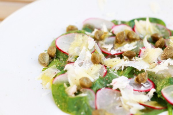 Spinach salad with capers, Parmesan cheese and radishes