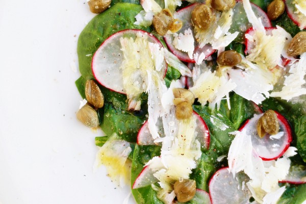 Spinach salad with capers, Parmesan cheese and radishes