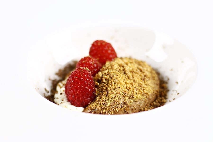 Chocolate mousse with white chocolate crumble and raspberries