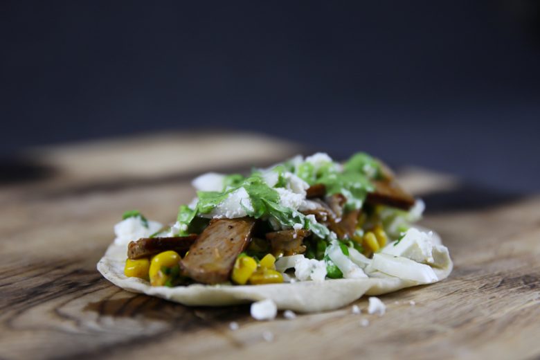 Pork Collar Taco with Chipotle Corn Salsa, Cilantro Sauce and Feta Cheese